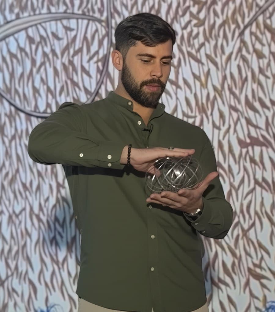 Tiago Braga segurando um toroide de fios, símbolo da geometria do campo
